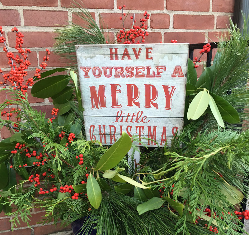 Have Yourself a Merry Little Christmas sign among greenery