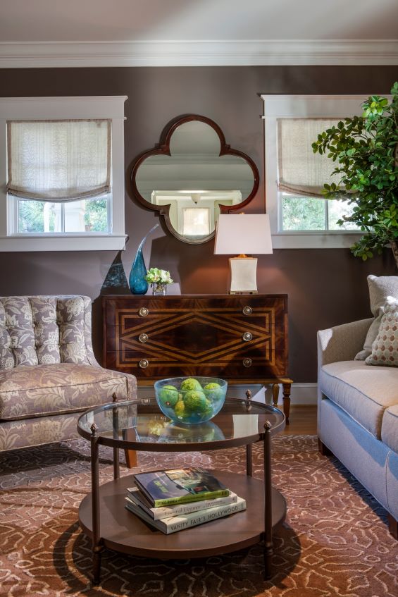 Transitional design in rich aubergine and sophisticated neutrals create warm living room by A. Houck Designs