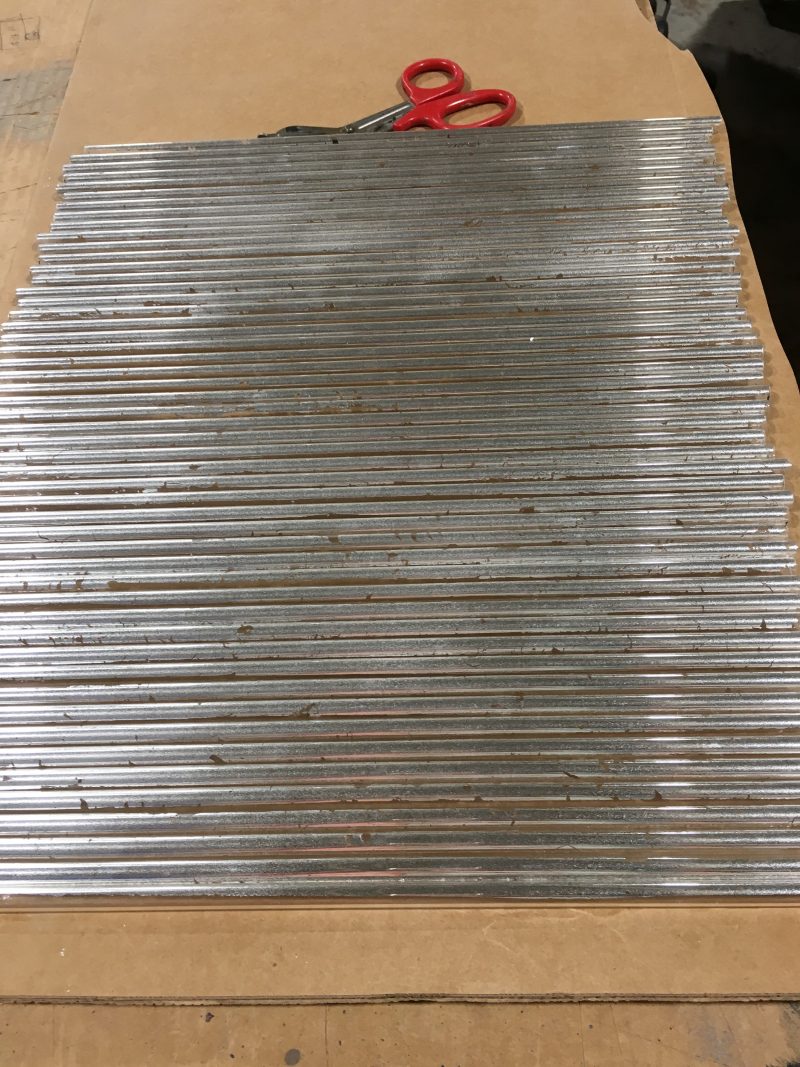 Silver-leafed glass rods before application to sconces