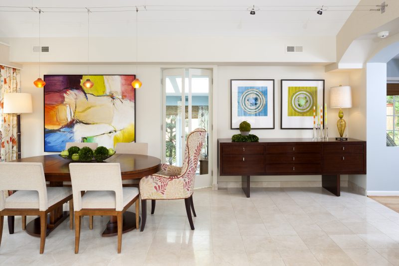 Dining area in open great room featuring vibrant colors, patterns and artwork