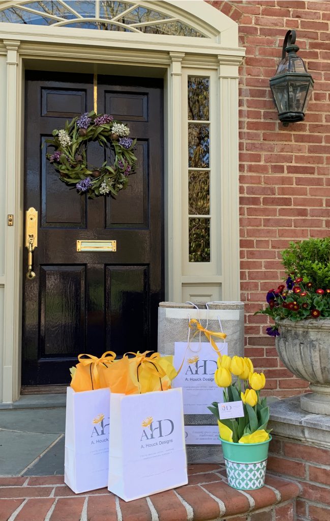 Sample bags with A. Houck Designs name and fresh flowers on front doorstep.