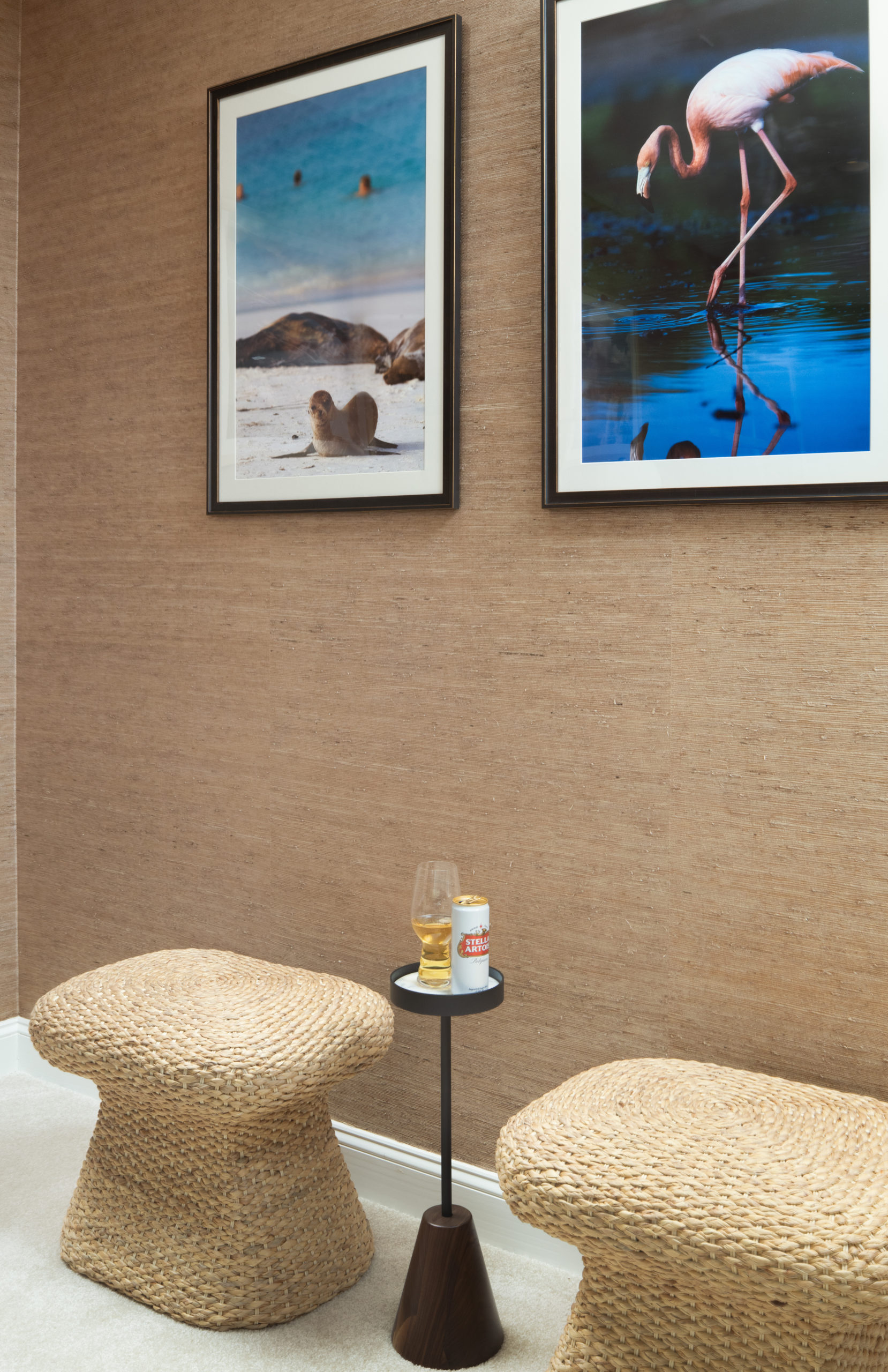 Billiards room vignette with woven stools and colorful art