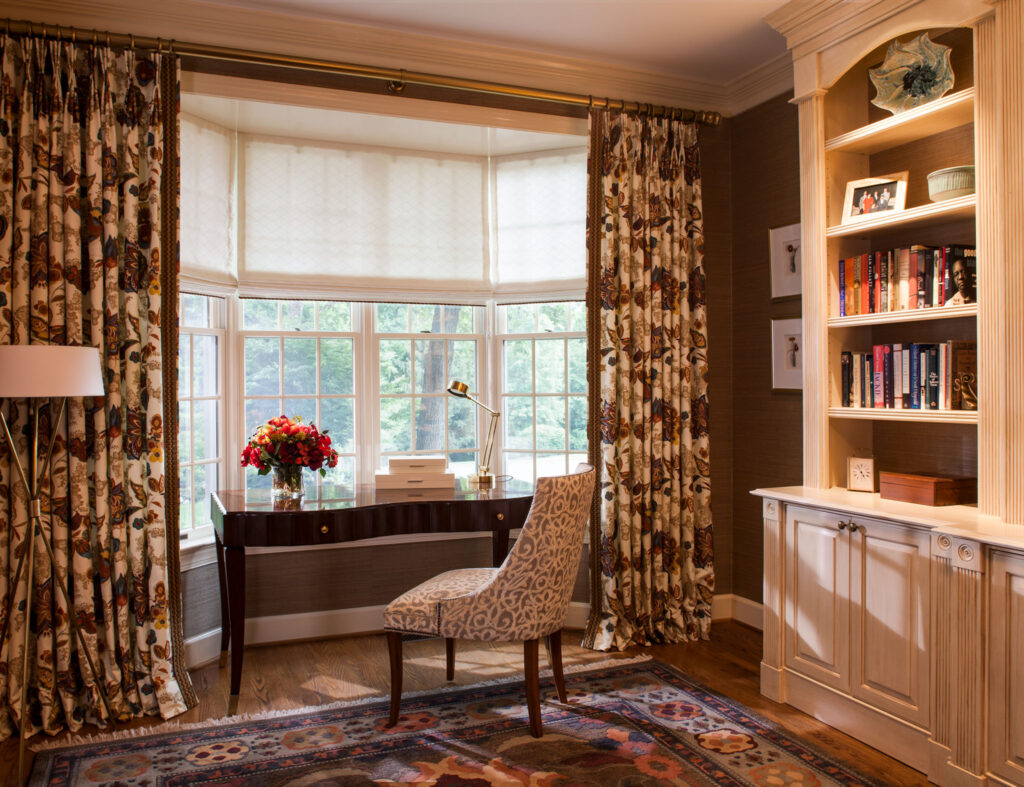 Clients' study with desk positioned in front of window with view of trees.