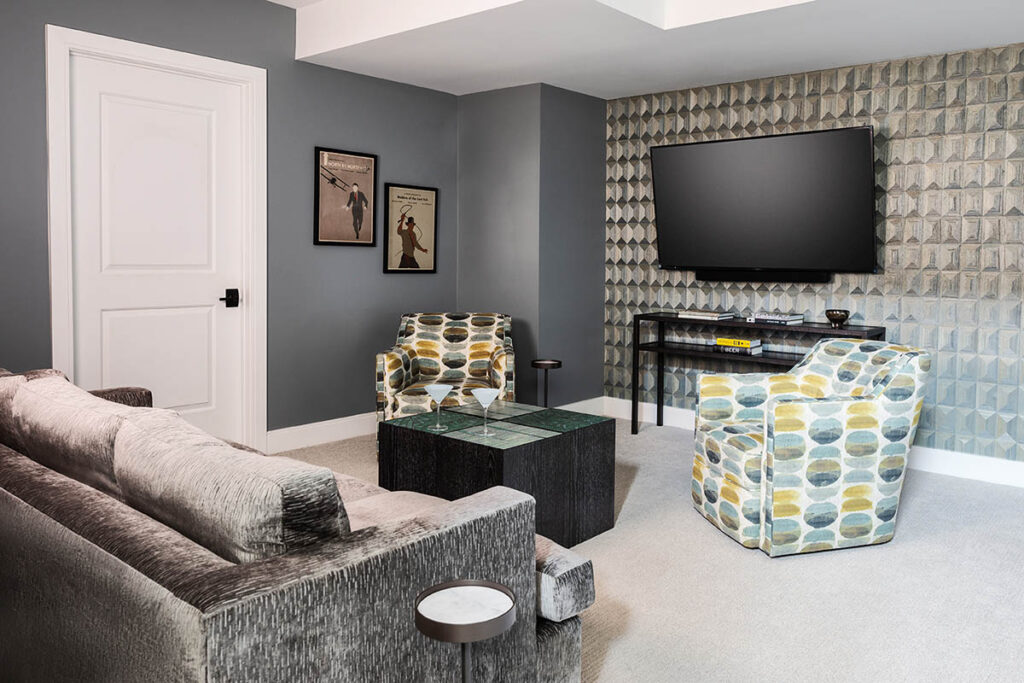 Seating area design detail with sofa, upholstered chair, wood wallcovering.