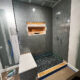 bathroom renovation in progress with new shower bench and picket shower wall tile