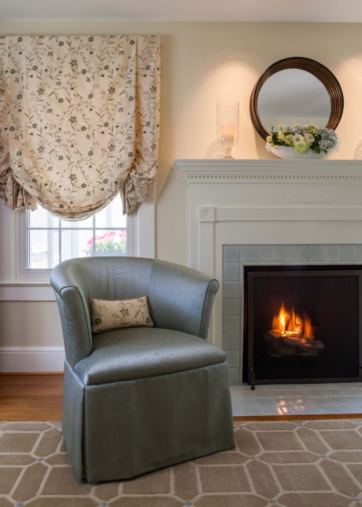 European charm in French blue living room. Chair and window treatment detail.