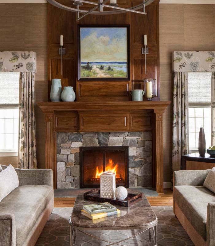 Family room with a stone fireplace, modern furniture, and warm lighting.