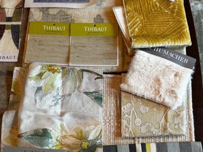 Fabric swatches and furniture layout plan for the living room design, featuring neutral tones and patterns.