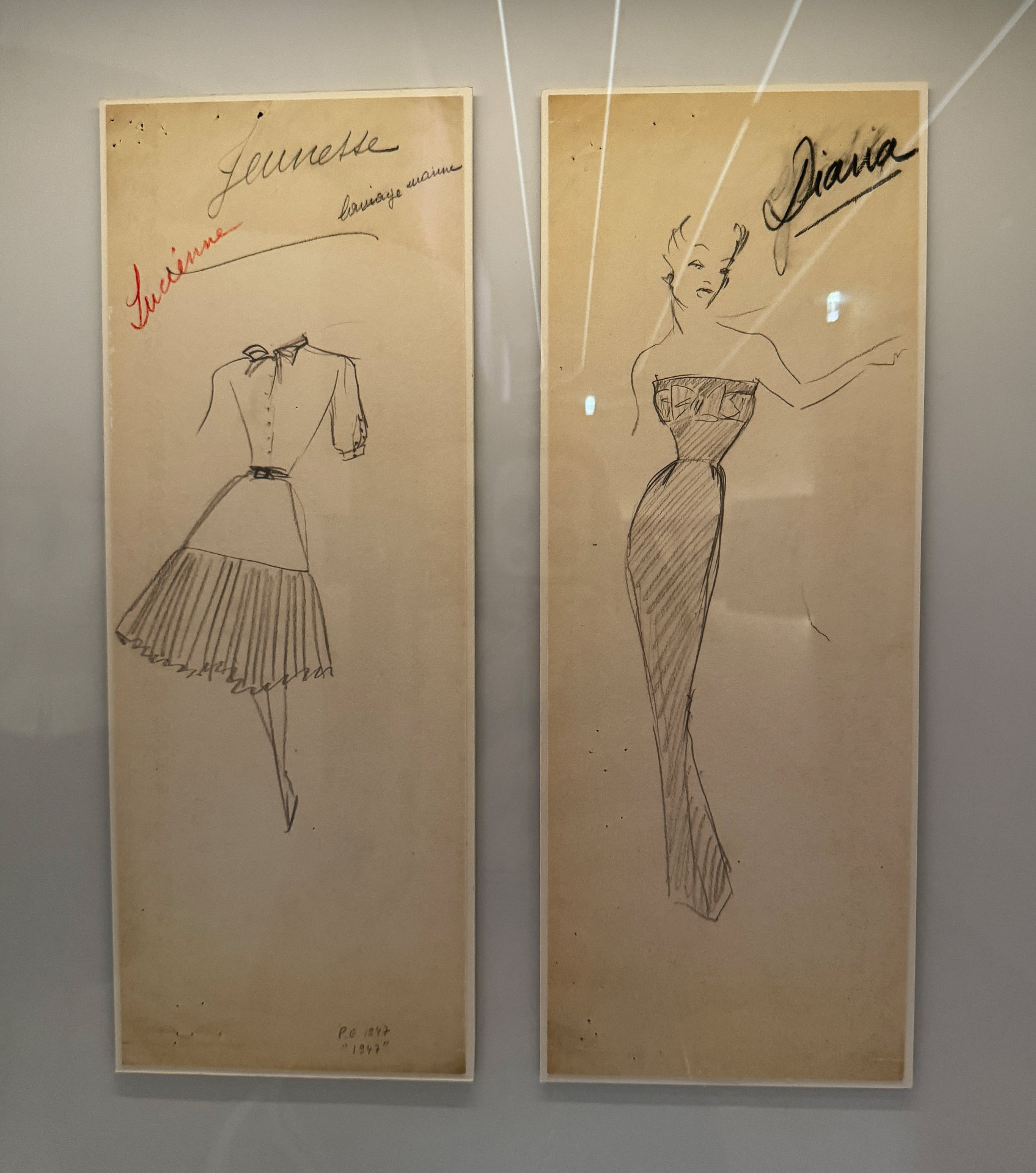 Fashion sketches featuring elegant designs for dresses, labeled Lucienne and Diana, displayed in a gallery.