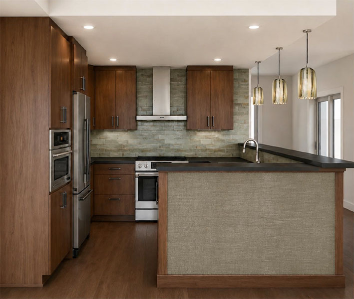 Modern kitchen with wood cabinets, stainless steel appliances, and pendant lighting above a sleek island countertop.